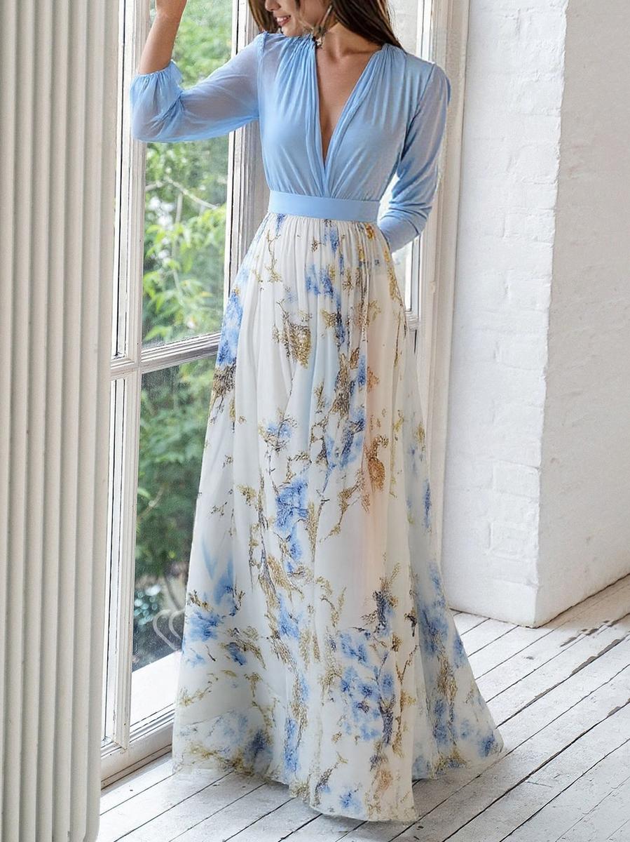 Woman model showcasing a V-neck floral maxi dress on a clean background.