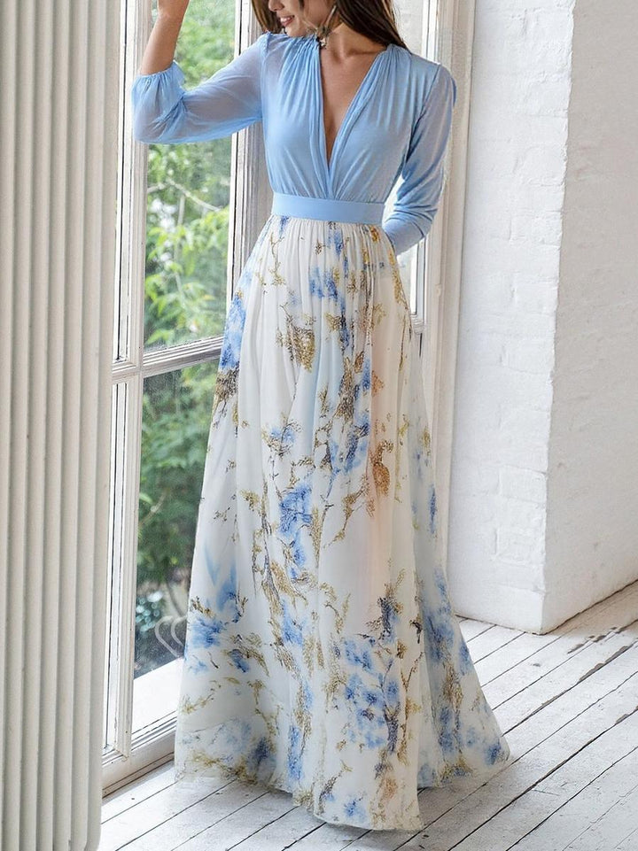 Woman model showcasing a V-neck floral maxi dress on a clean background.