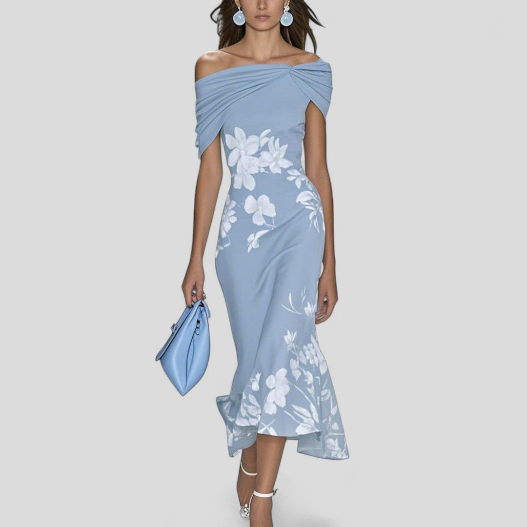 Woman model in a fitted floral midi dress with trumpet hem on a clean background.