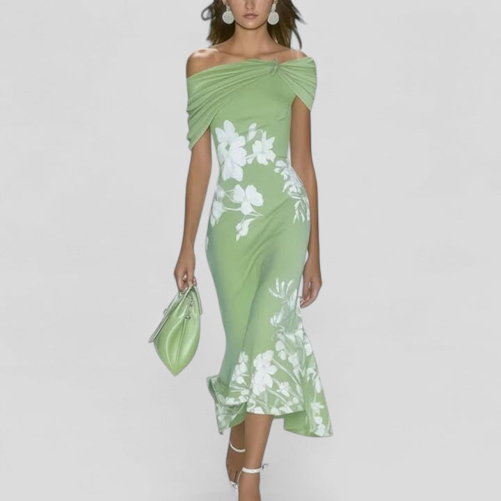Woman model wearing a floral off shoulder midi dress on a plain background.