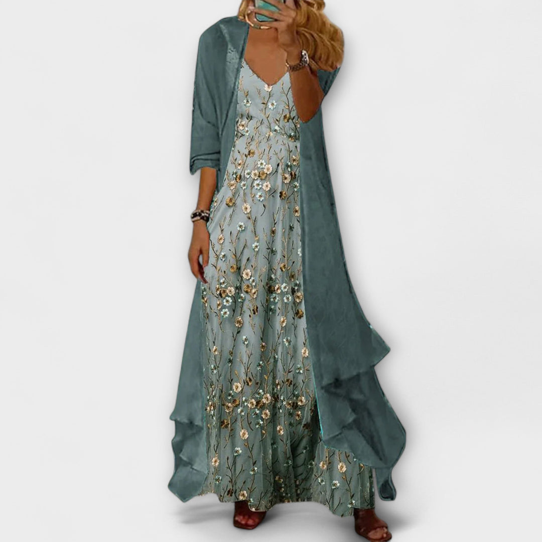 Elegant woman model posing in a V-neck floral maxi dress on a clean backdrop.