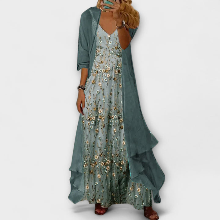 Elegant woman model posing in a V-neck floral maxi dress on a clean backdrop.