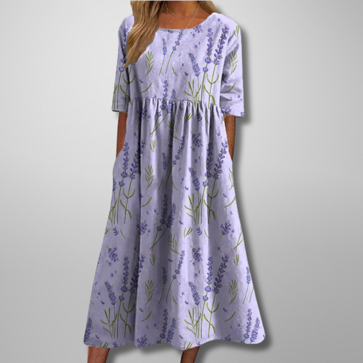 Woman model wearing a casual floral summer maxi dress on a clean background.