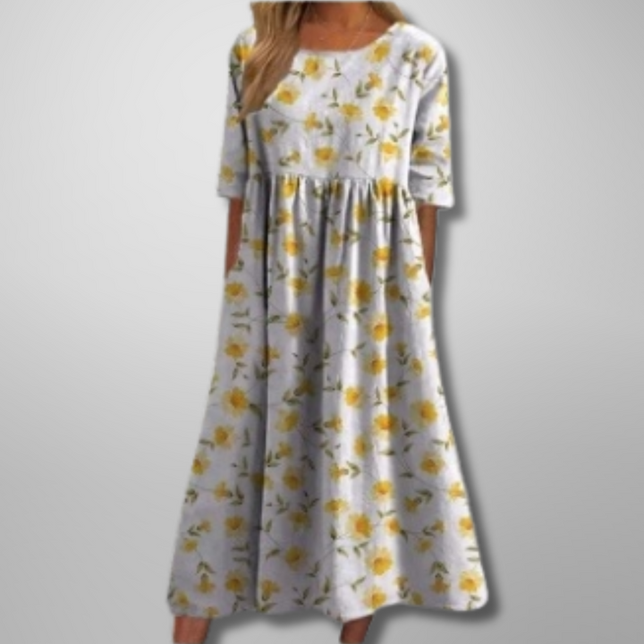 Model in a true to size floral maxi dress on a clean background.
