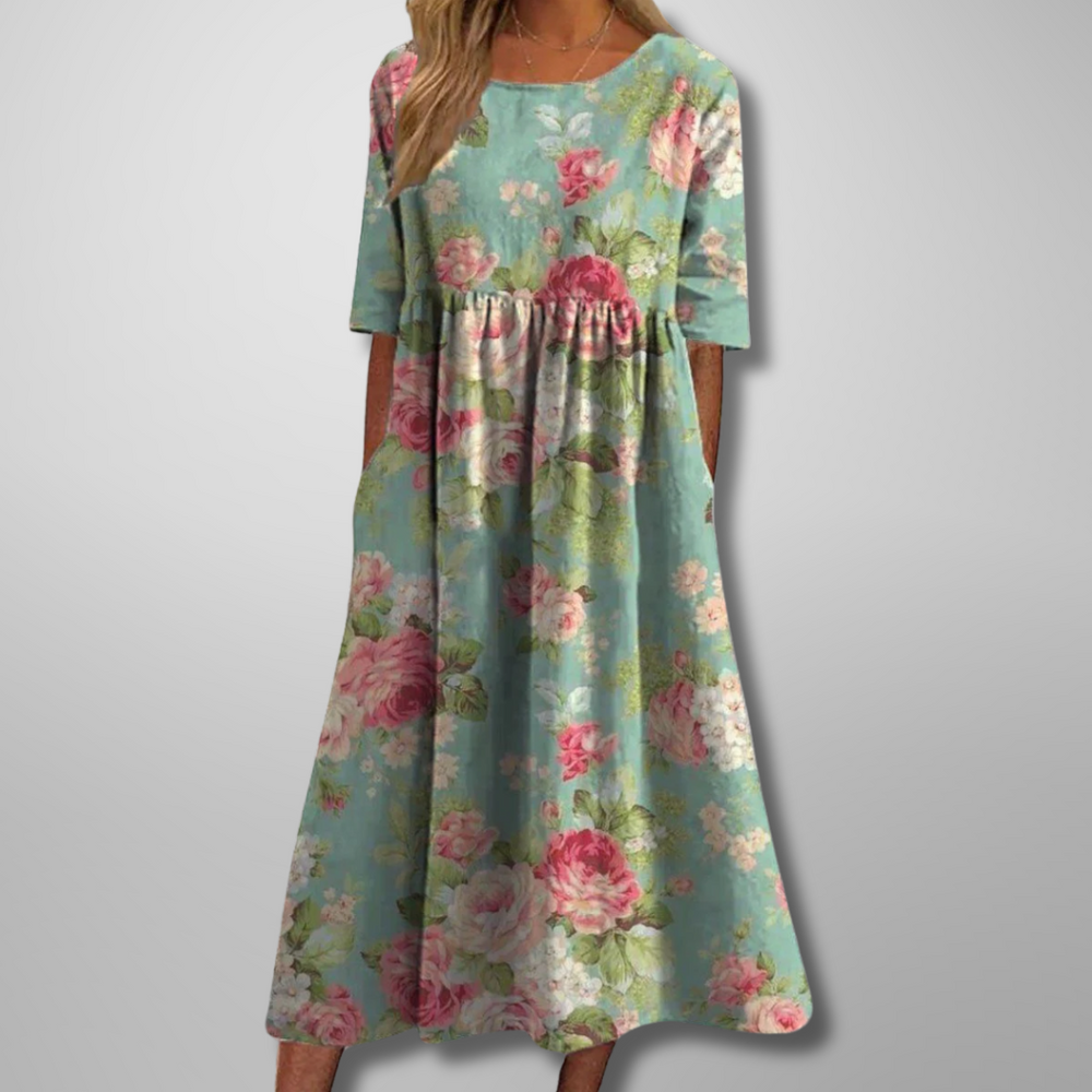 Model in a relaxed floral maxi dress with 3/4 sleeves on a clean background.