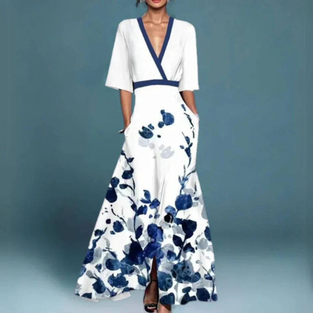 Female model in a floral V-neck maxi dress with short sleeves on a plain background.