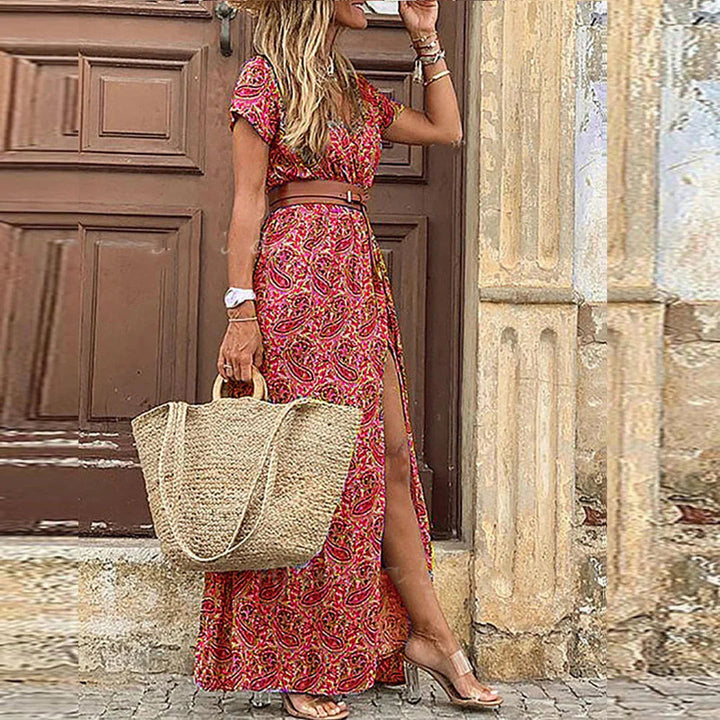 Elegant floral wrap dress worn by a woman model on a wooden background.