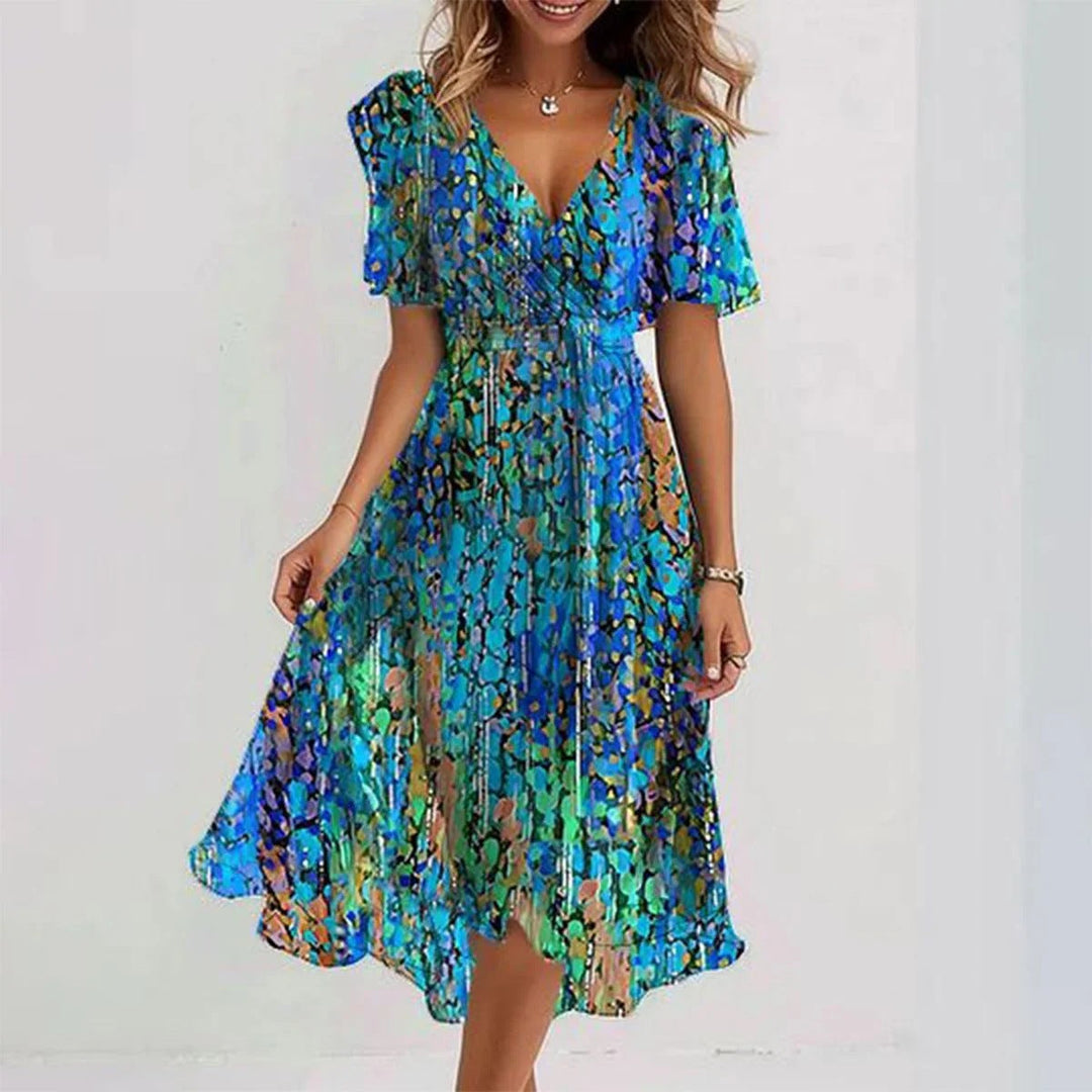 Female model showcasing a summer floral wrap dress with a plain backdrop.