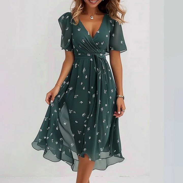 Woman model wearing a floral wrap midi dress on a clean background.