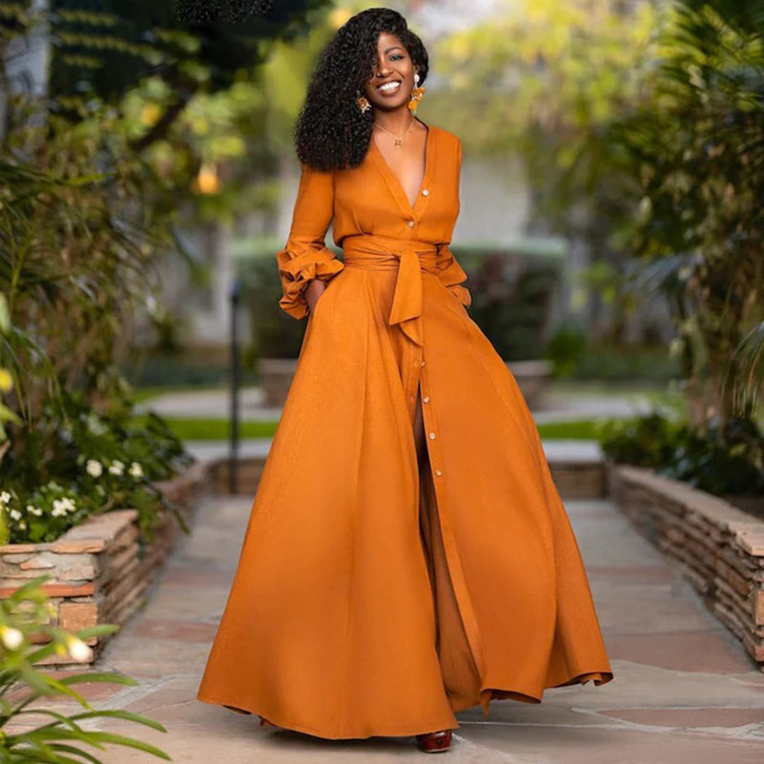 Woman model wearing a flowing maxi dress on a nature background.