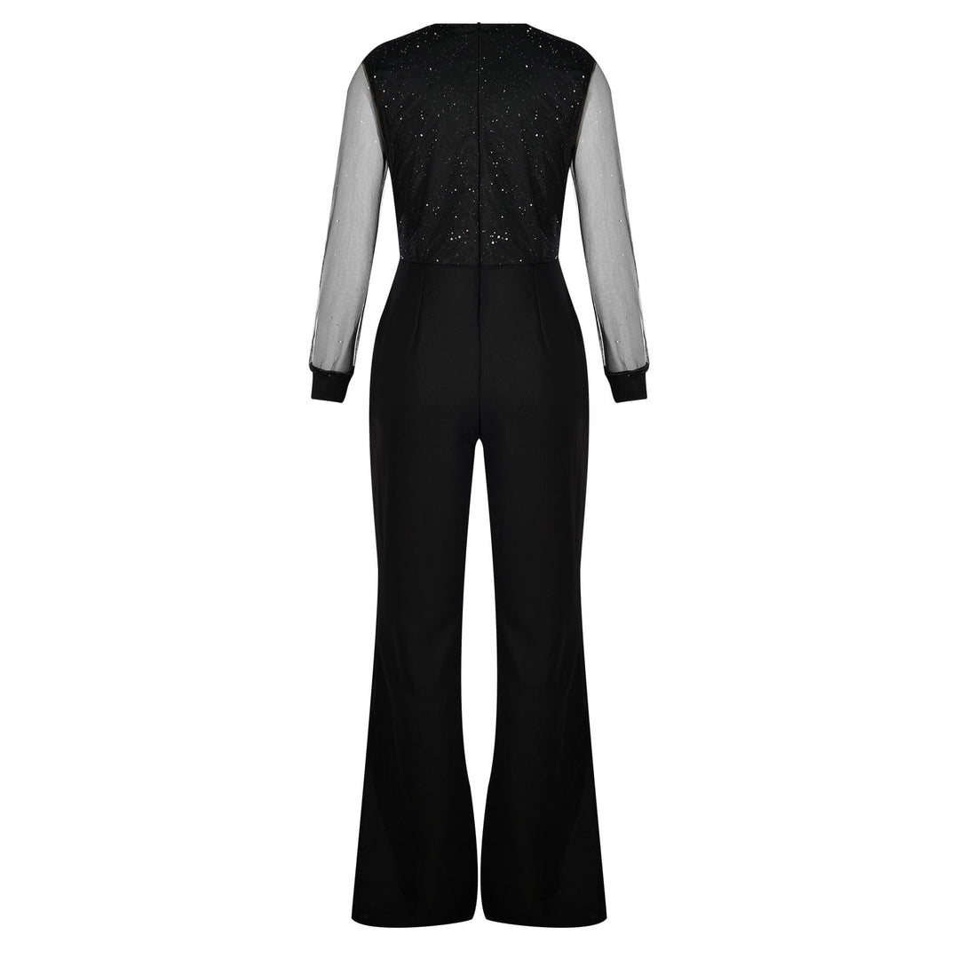 Model standing confidently in black jumpsuit plain background minimal style