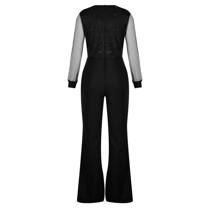 Model standing confidently in black jumpsuit plain background minimal style