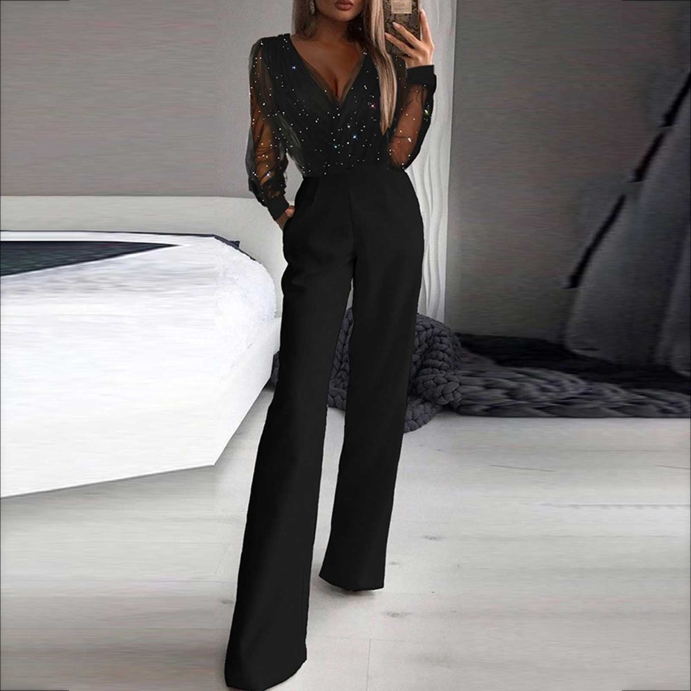 Model posing sideways in elegant jumpsuit plain background fashion look