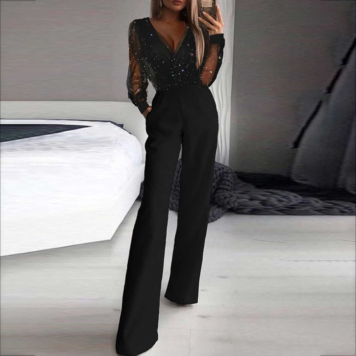 Model posing sideways in elegant jumpsuit plain background fashion look