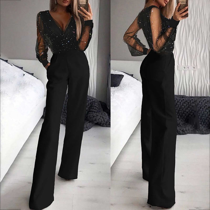 Model wearing black jumpsuit front view living area background stylish pose