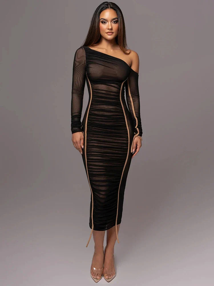Woman model styled in a sleek one-shoulder ruched dress on a plain background.