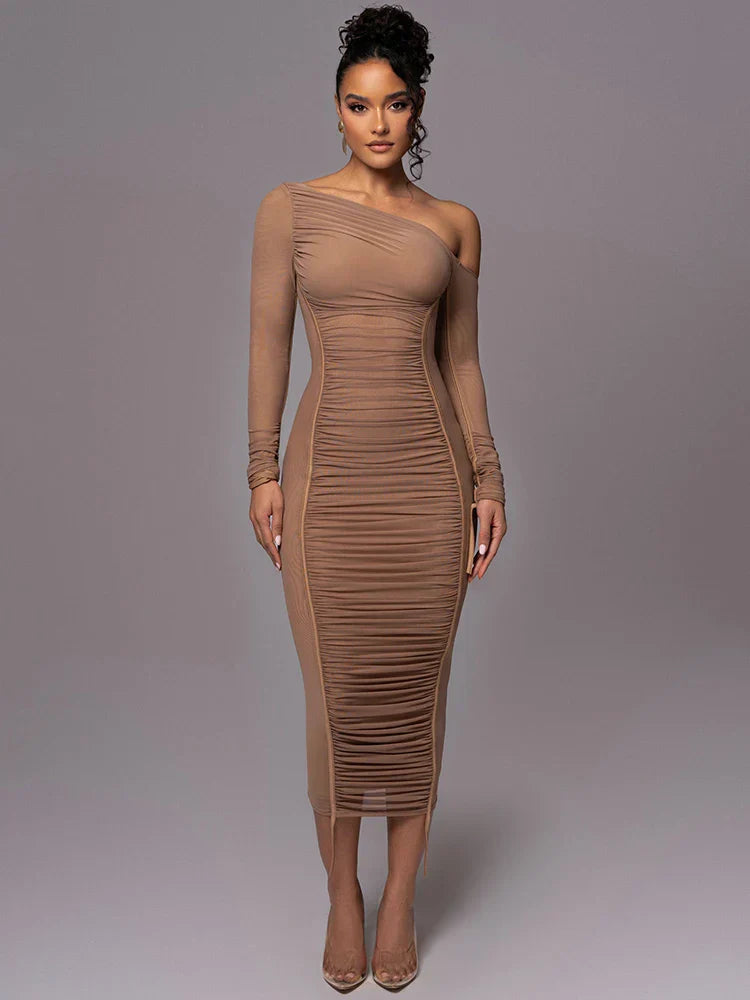 Model posing in a chic ruched bodycon dress on a clean background.