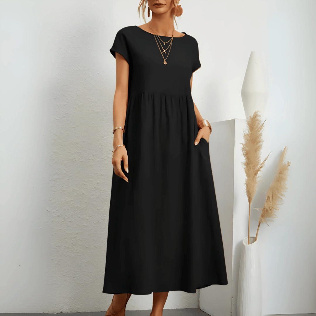 Woman model showcasing a casual A-line midi dress with side pockets.