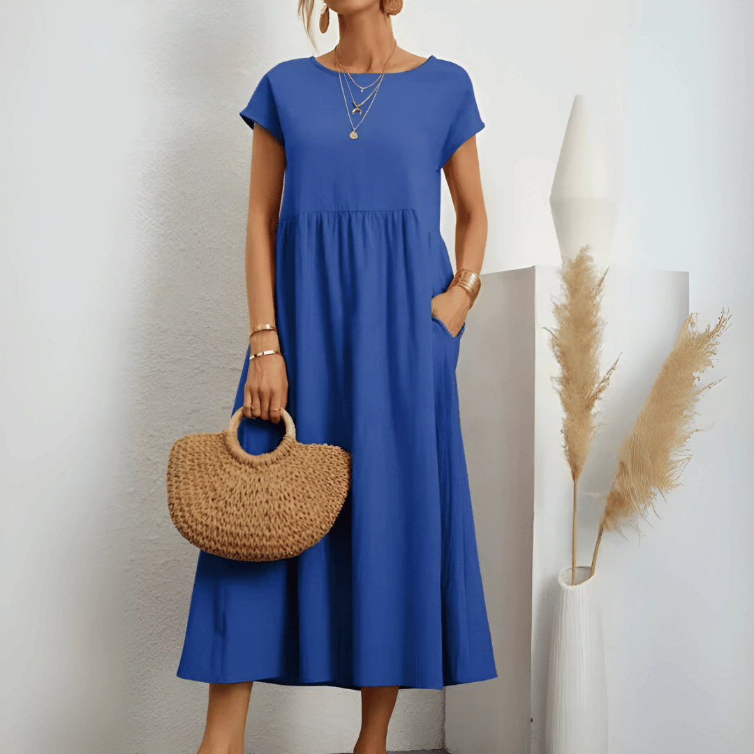 Woman model wearing a round neck midi dress against a clean background.