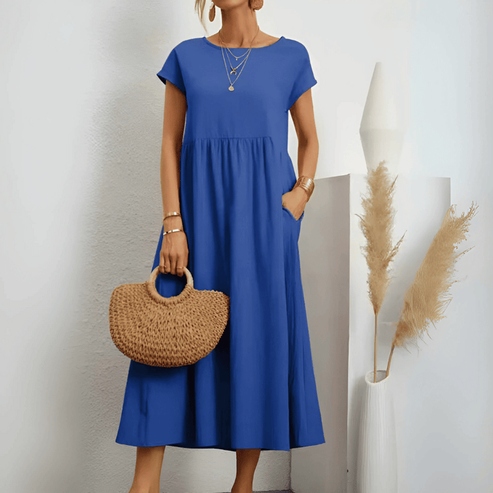 Woman model wearing a round neck midi dress against a clean background.
