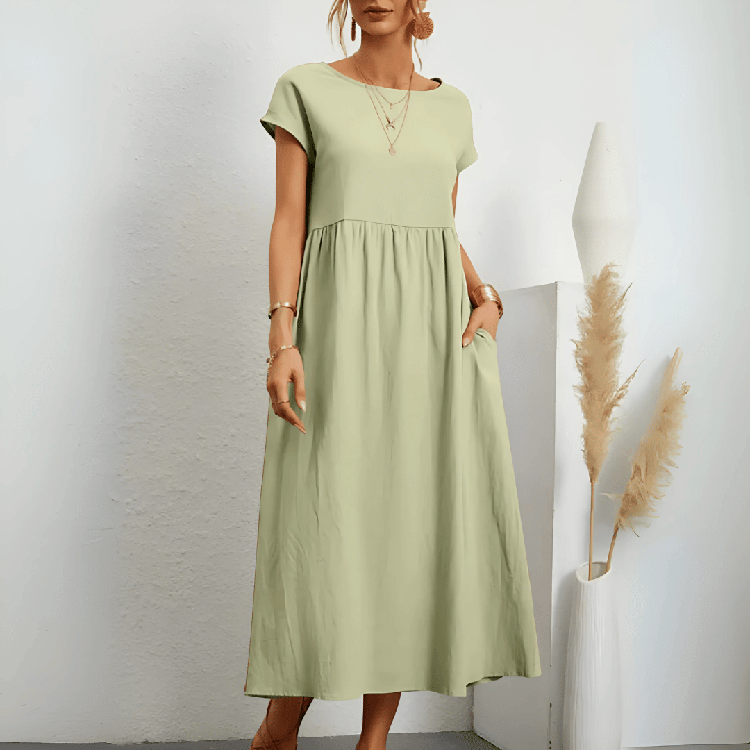 Model posing in a flattering A-line dress on a plain background.