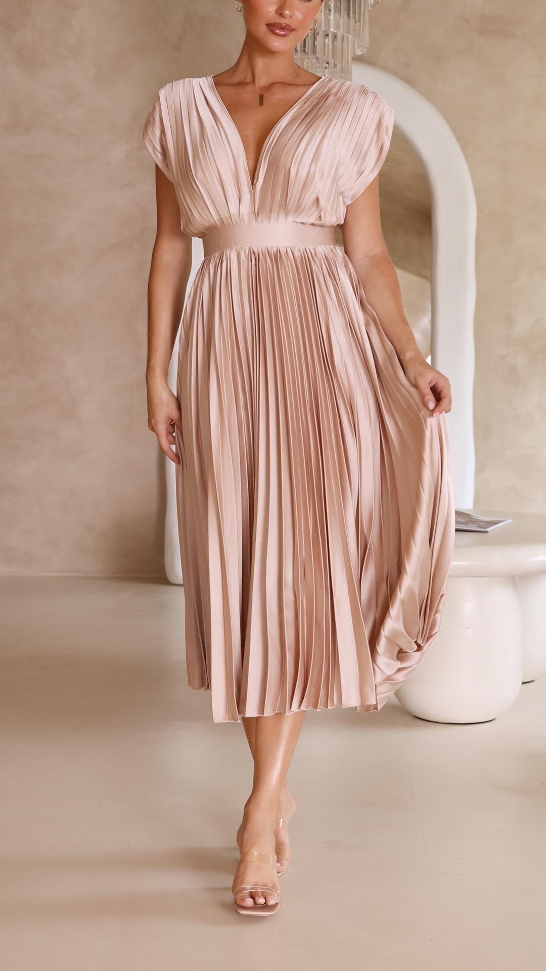 Woman model wearing a lightweight pleated dress for warm weather styling.