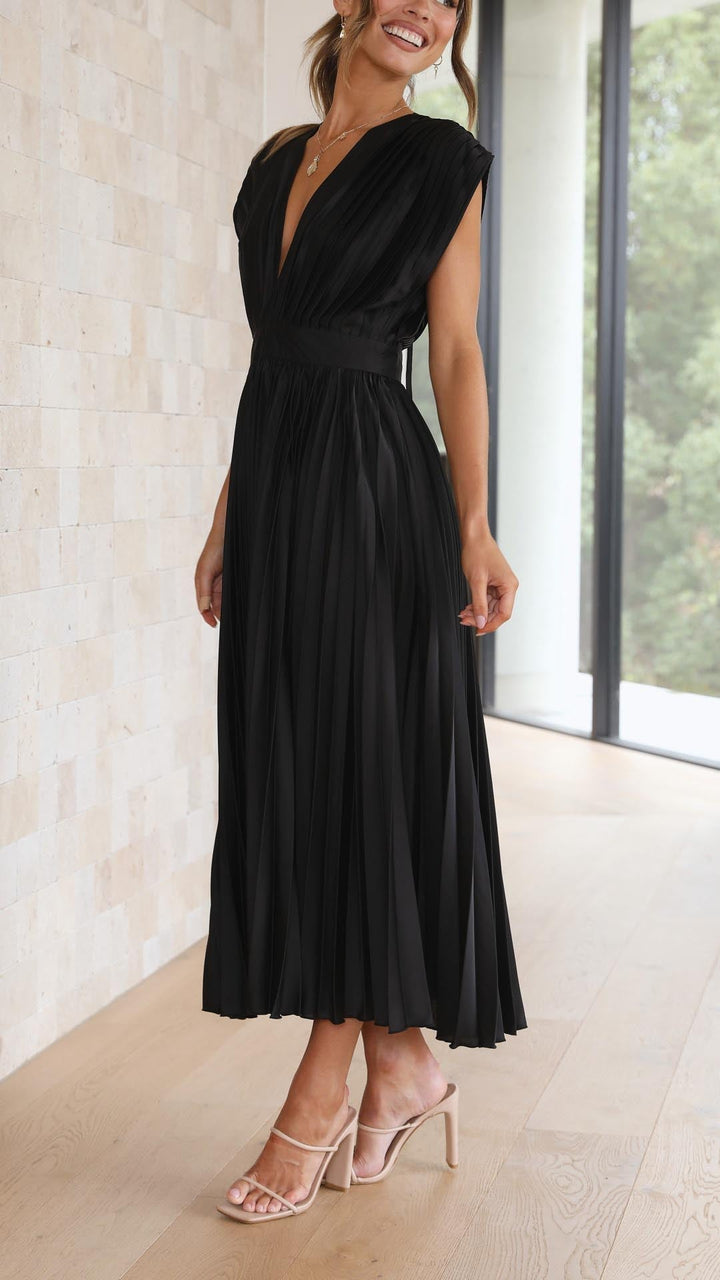 Woman model wearing a feminine V-neck midi dress with pleated skirt.