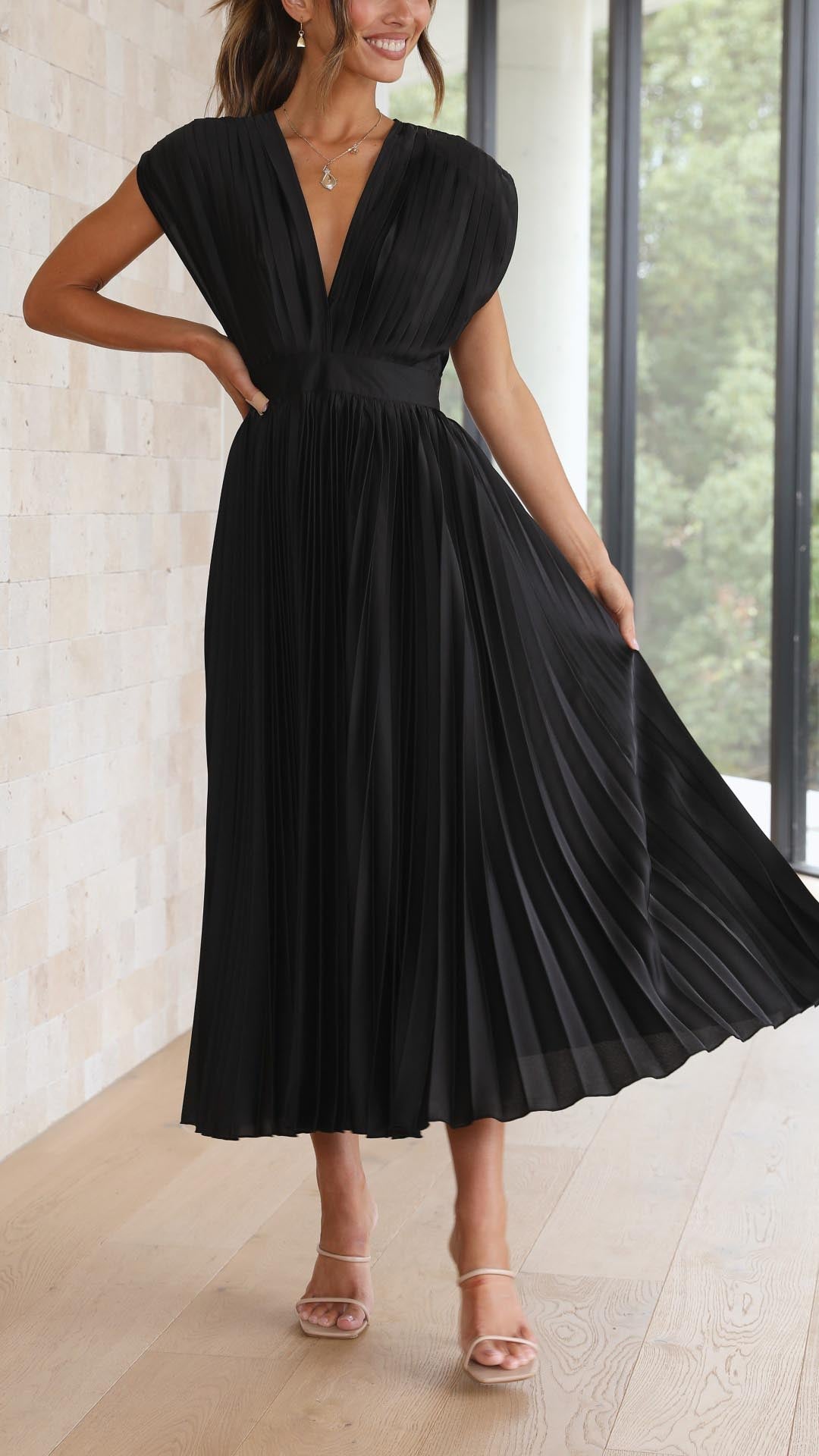 Lightweight women’s pleated midi dress shown on a woman model.