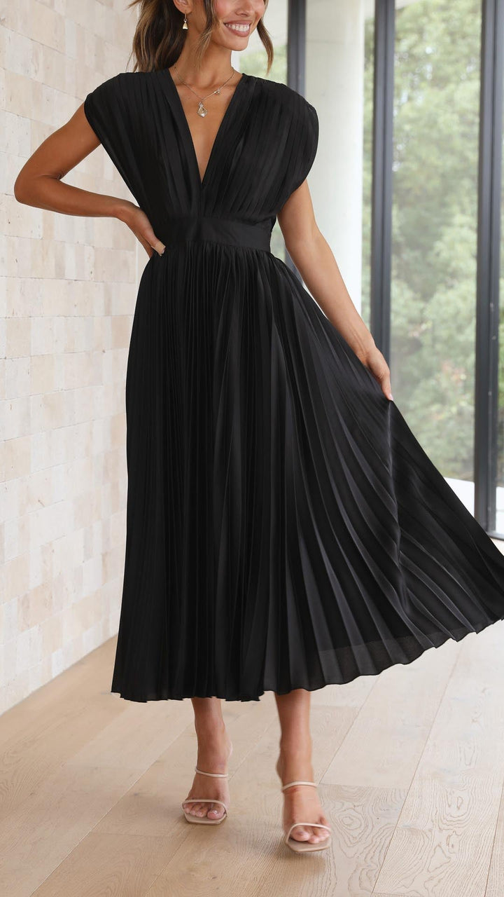 Lightweight women’s pleated midi dress shown on a woman model.