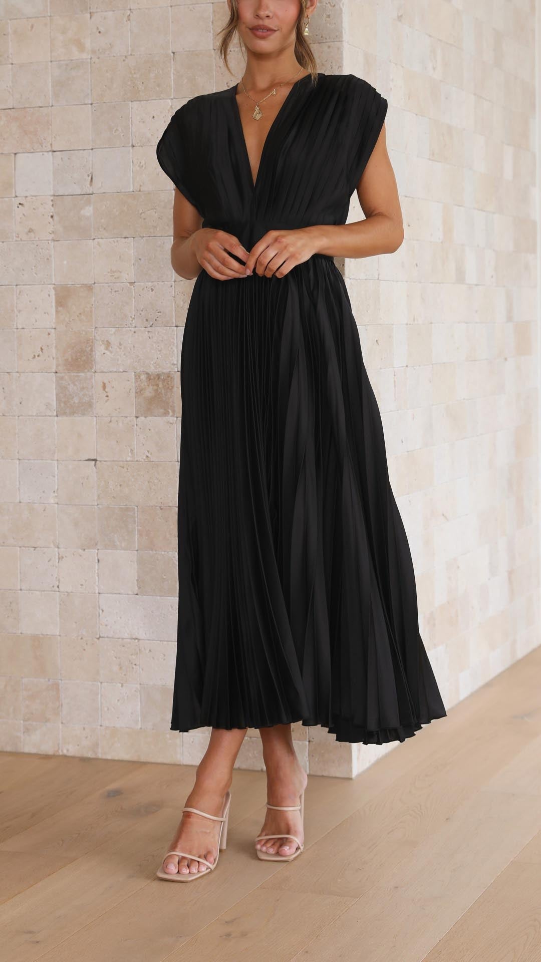 Pleated skirt midi dress worn by a woman model against a plain background.