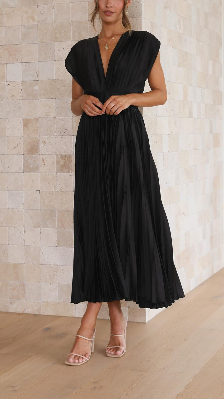 Pleated skirt midi dress worn by a woman model against a plain background.