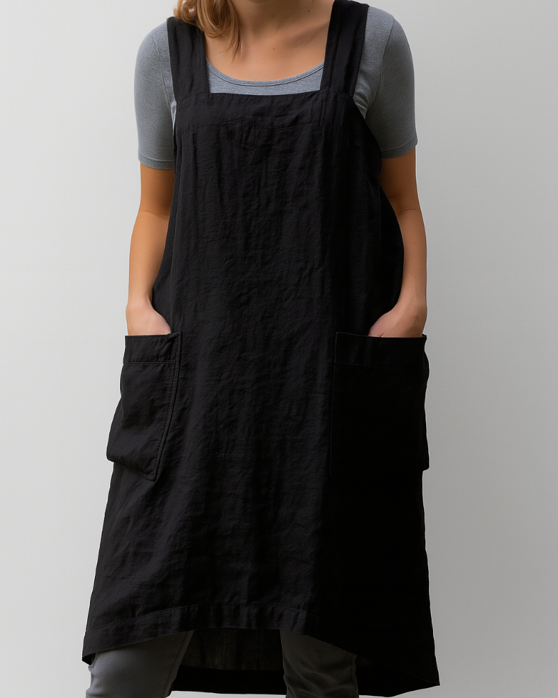 Woman model displaying a timeless apron style midi dress on a plain background.