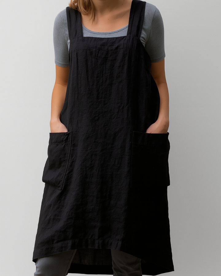 Woman model displaying a timeless apron style midi dress on a plain background.