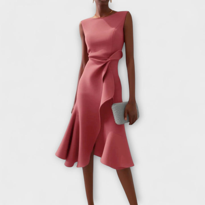 Sleeveless asymmetrical midi dress showcased on a woman model with clean backdrop.