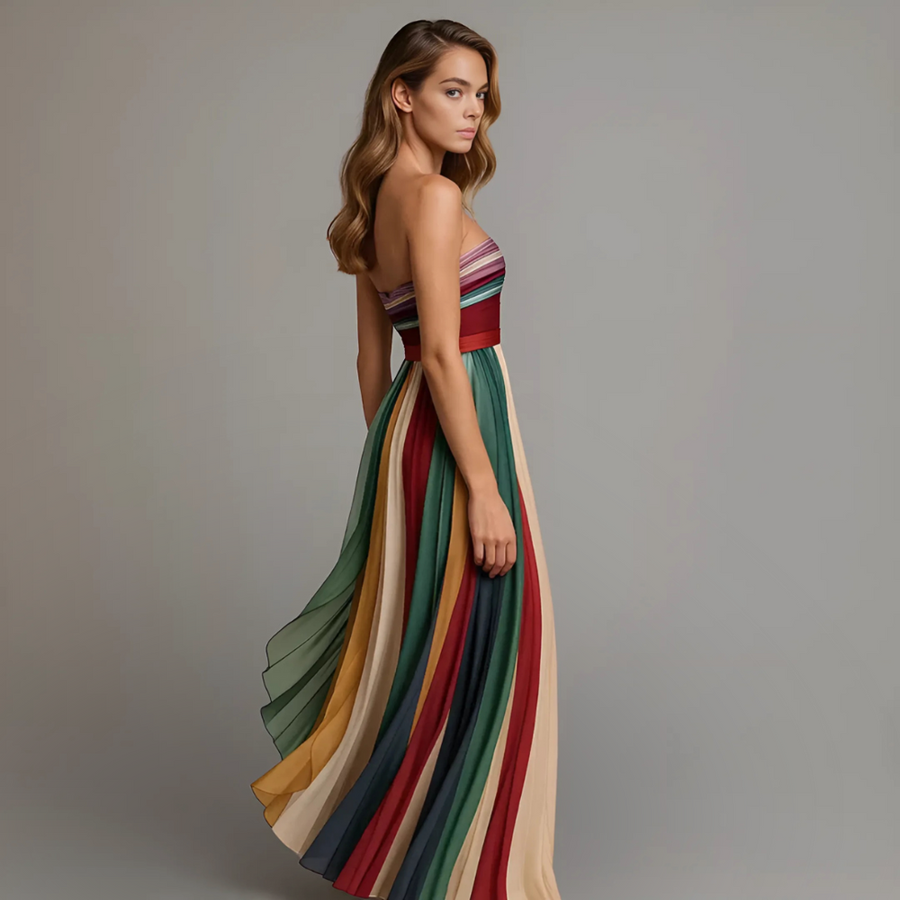 Woman model wearing a strapless A-line maxi dress on a clean background, side view