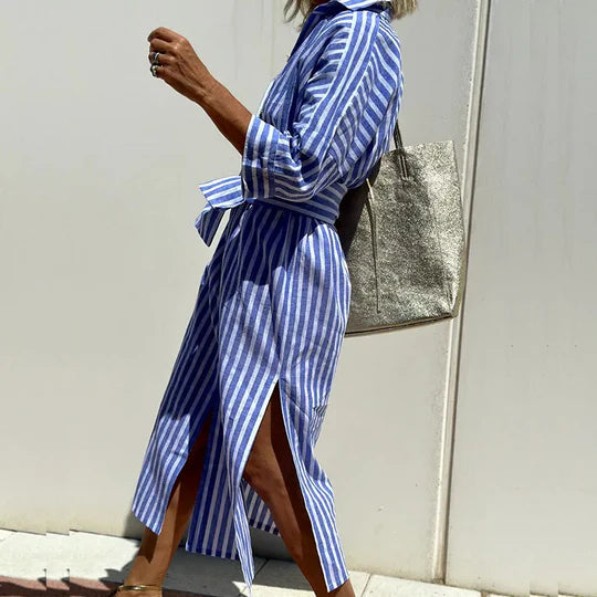 Woman model showcasing a button-down striped midi dress with side slit.