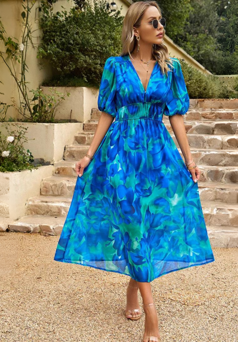 Floral print midi dress with elastic waist displayed on a woman model on a clean background.