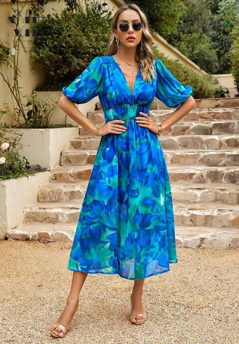Floral midi dress with feminine shape shown on a woman model against a clean background.