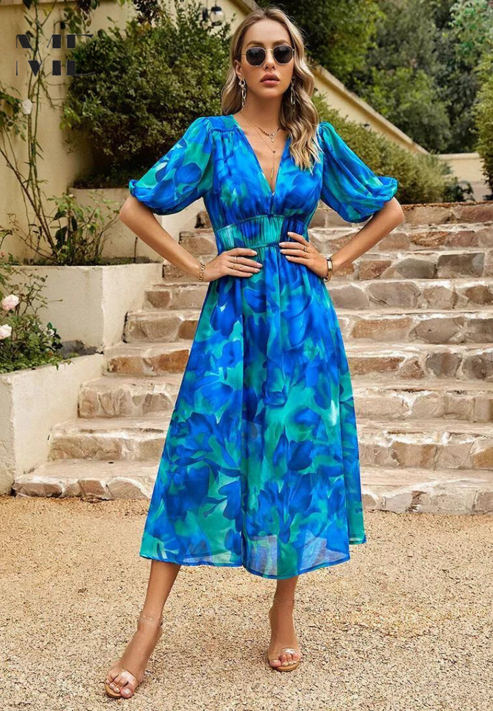 Floral midi dress with feminine shape shown on a woman model against a clean background.