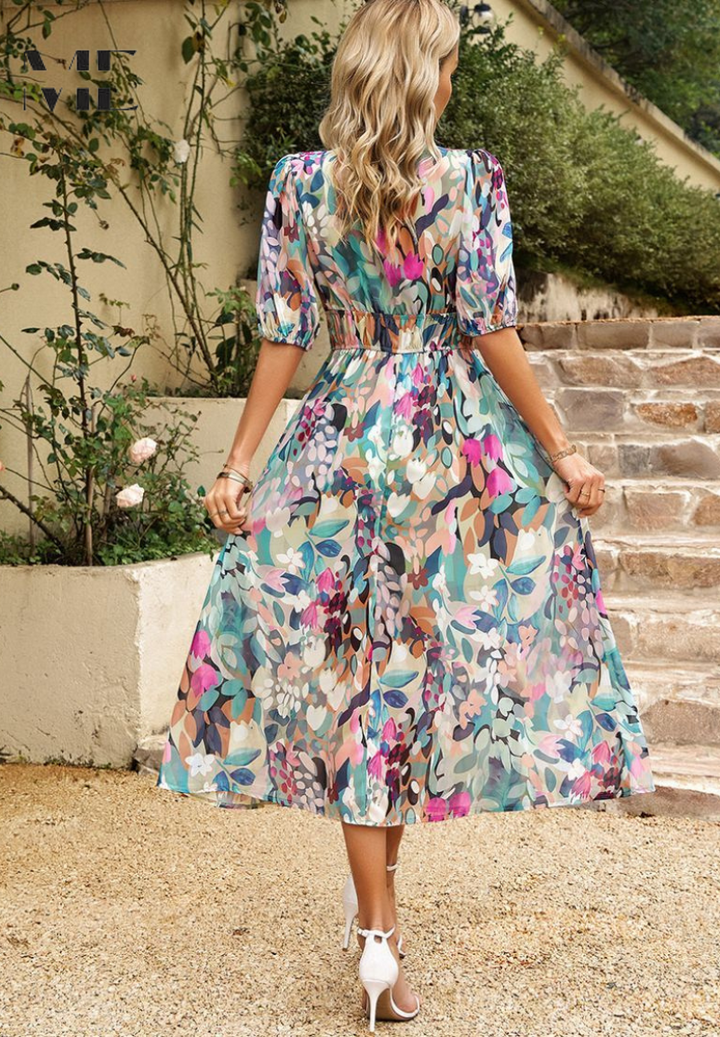 Back view, Model in a floral midi dress featuring an A-line skirt and elastic waist on a clean background.