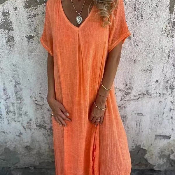 Woman model showcasing a flattering V-neck midi dress on a plain background.