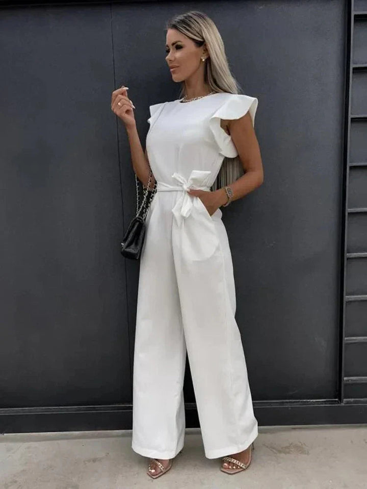Model front pose with ruffle sleeves detail plain background